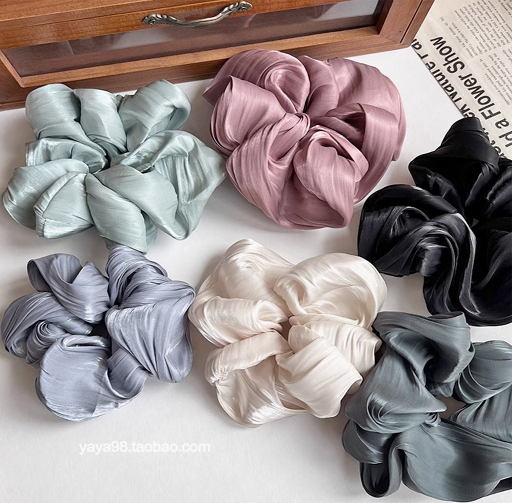 It is a stylish and playful hair accessory that combines sparkle with a unique wavy design.